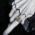A close-up of a white articulated robotic hand wearing a silver ring engraved with '200 Jrs. Champion' and 'The Great White Hunter'.